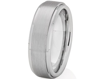 May include: A silver-toned tungsten carbide ring with a brushed finish. The ring has a beveled edge and a flat top.