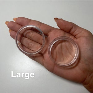 May include: Two clear plastic rings, one larger than the other, labelled "Large".