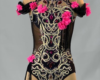May include: Black leotard with gold embroidery and pink fabric flowers. The leotard has a sheer mesh fabric and black fringe accents.
