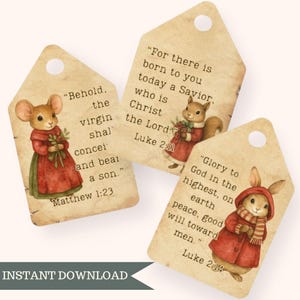 May include: Three vintage-style gift tags with illustrations of woodland creatures in red coats. Each tag features a Bible verse: Matthew 1:23, Luke 2:11, and Luke 2:14. The tags have a distressed, aged appearance and a hole at the top.