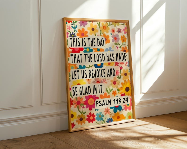 May include: A framed print with a colorful floral background and a quote from Psalm 118:24. The quote reads "This is the day that the Lord has made: Let us rejoice and be glad in it."