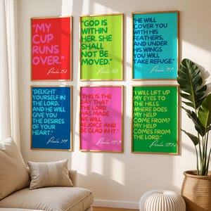 May include: Six colorful framed prints with inspirational quotes from the Bible. Each print features a different color background and white text. The prints are arranged in a grid pattern on a white wall.