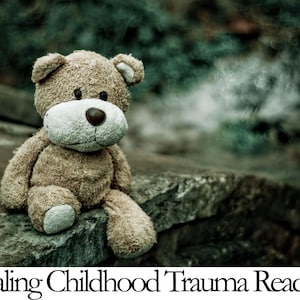 A teddy bear sits on a rock, with a blurred natural background, accompanied by the text "Healing Childhood Trauma Reading".
