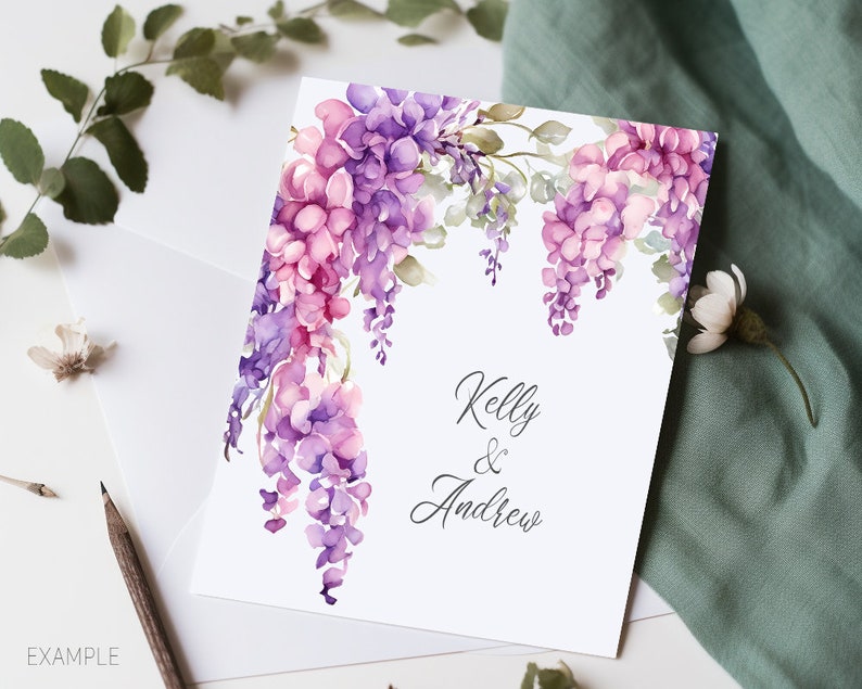 May include: A white card with a watercolor illustration of purple and pink flowers. The text "Kelly & Andrew" is written in black cursive.