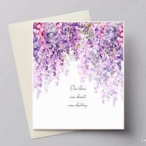 May include: A white card with a watercolor illustration of purple and pink wisteria flowers. The text "One love, one heart, one destiny" is printed on the card.