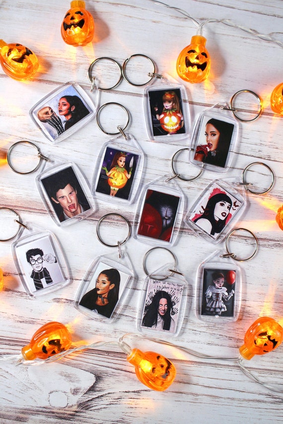 Halloween Themed Keychains With Various Prints Of Handmade Drawings Of Ariana Grande Shawn Mendes Billie Eilish And Pennywise From It