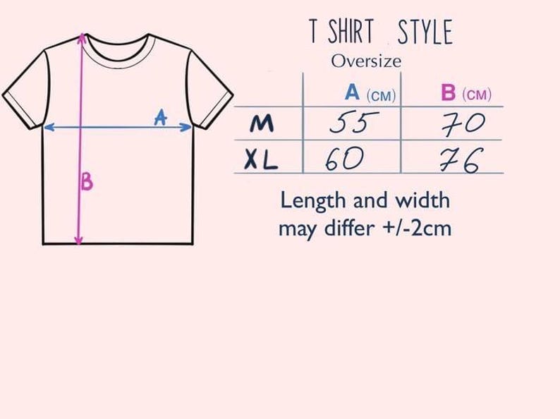 May include: A diagram showing the measurements for an oversized t-shirt in centimeters. The diagram shows a t-shirt with the measurements labeled A and B. The table shows the measurements for sizes M and XL.  The text below the table reads "Length and width may differ +/-2cm."