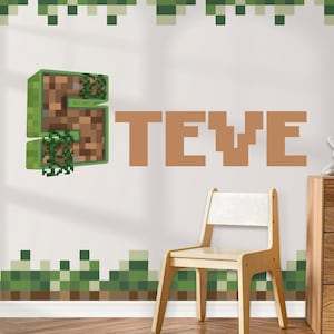 May include: A wall decal featuring the name "TEVE" in brown block letters, with a pixelated "S" design incorporating soil and greenery. The room includes a wooden chair and pixelated green and brown border.