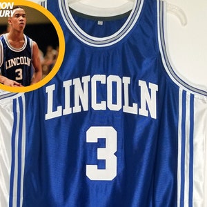 May include: A blue basketball jersey with white lettering. The jersey has the word "LINCOLN" and the number "3" on the front. The jersey is on a hanger.