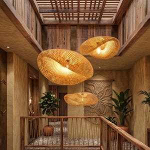 May include: Three woven rattan pendant lights hang in a hallway with wooden features. The lights are oval-shaped, with a warm, natural colour. The hallway includes plants, a macrame wall hanging, and a wooden railing, creating a natural, inviting atmosphere.