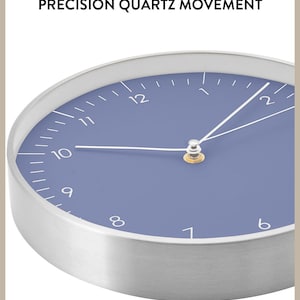 May include: A silver and blue round clock with a white face and black numbers. The clock has a silver rim and a white minute hand and hour hand. The clock face is a light blue color. The clock says "PRECISION QUARTZ MOVEMENT" at the top.