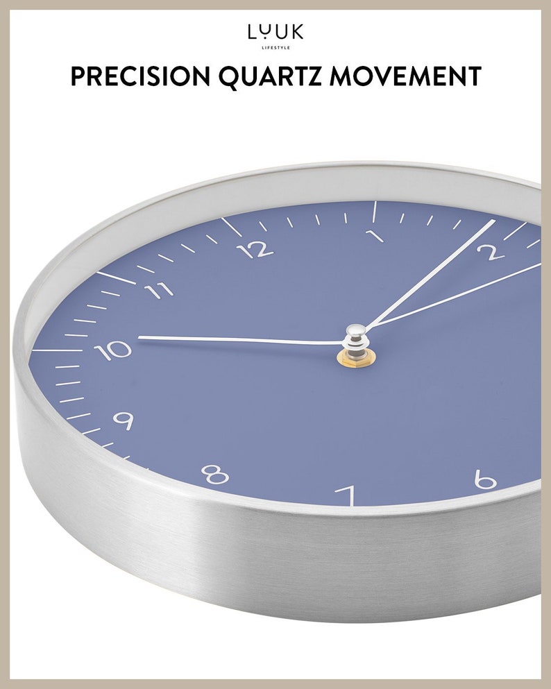 May include: A silver and blue round clock with a white face and black numbers. The clock has a silver rim and a white minute hand and hour hand. The clock face is a light blue color. The clock says "PRECISION QUARTZ MOVEMENT" at the top.