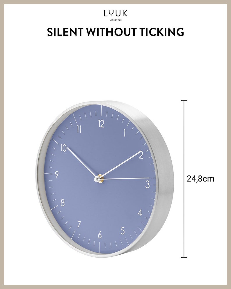 May include: A silver and blue wall clock with white hands and a diameter of 24.8 inches. The clock face is a light blue color with white numbers and a gold center. The clock is silent and does not tick.