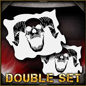 May include: Two white stencils of a skull with horns. The skull is detailed with teeth and a large open mouth. The stencils are labeled "DOUBLE SET".