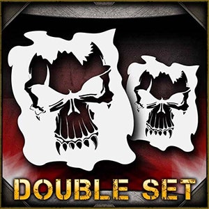 May include: A double set of skull stencils, each featuring a detailed skull design with sharp teeth. The stencils are white and cut out against a black background. The text "DOUBLE SET" is printed in yellow at the bottom of the image.