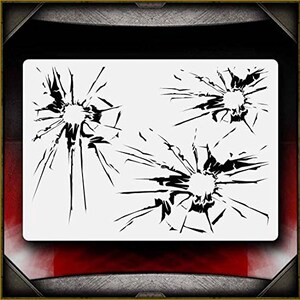 May include: A stencil with three different designs of broken glass. Each design features a circular hole with radiating cracks.
