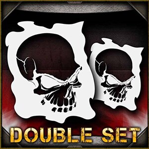 May include: A double set of skull stencils, each with a detailed design of a skull with a menacing expression. The stencils are white and are set against a red background. The text "DOUBLE SET" is printed in yellow at the bottom of the image.