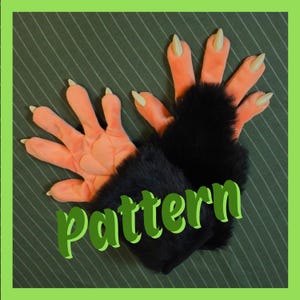 May include: A pair of gloves featuring peach-colored fabric palms with five fingers, each tipped with a pointed beige claw. The wrist area is covered in thick black faux fur. The word pattern is printed in green across the center of the gloves.