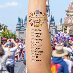 May include: A temporary tattoo on an arm featuring a colorful design with the text "Sippin & Snacks Around The World!" and a list of countries. The background shows a theme park with a castle and a crowd of people.