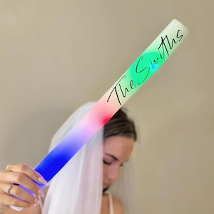 a woman in a wedding dress holding a tube with writing on it