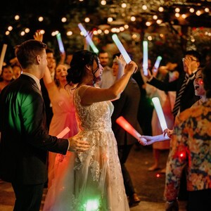 a bride and groom dancing with their guests