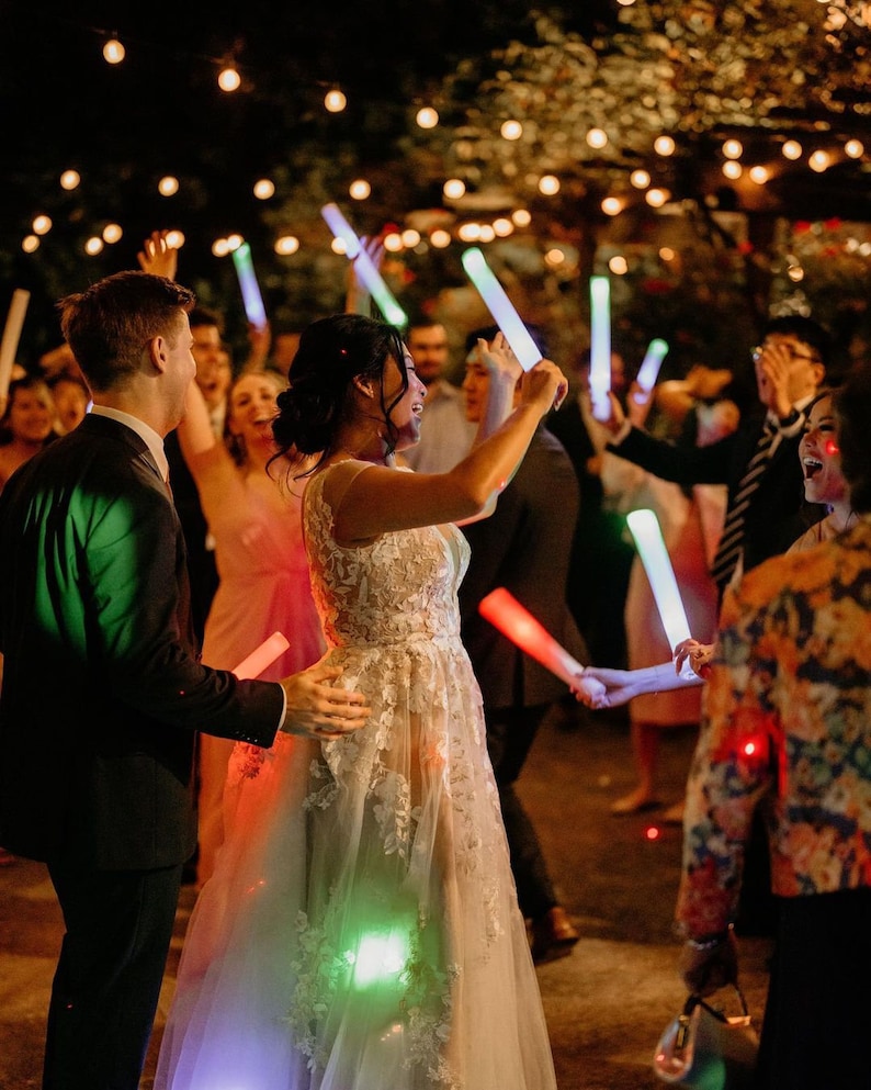 a bride and groom dancing with their guests