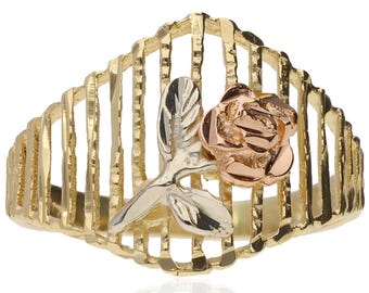 May include: A gold-tone ring featuring a rose design. The ring has a cage-like band with a rose and leaves in rose and silver tones. The rose is the focal point, with detailed petals. The leaves are silver, and the band is gold.