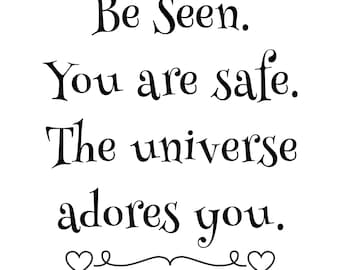May include: Black and white text on a white background that reads "Be Seen. You are safe. The universe adores you." with two hearts at the bottom.