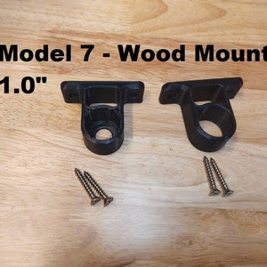 May include: Two black plastic wall mounts with screws, labeled "Model 7 - Wood Mount 1.0"