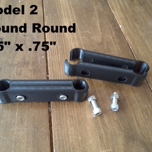 May include: Two black plastic brackets with two holes each, and two silver nuts. The brackets are labelled "Model 2 Round Round .75" x .75"