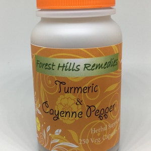 May include: A white plastic bottle with an orange lid, labeled "Forest Hills Remedies Turmeric & Cayenne Pepper Herbal Supplement 250 Veg. Capsules". The label has a yellow and orange background with a floral design.