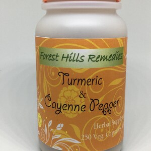 May include: A white plastic bottle with an orange lid, labeled "Forest Hills Remedies Turmeric & Cayenne Pepper Herbal Supplement 250 Veg. Capsules". The label has a yellow and white floral design.