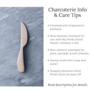 May include: A light-colored wooden charcuterie knife with a curved blade and handle. The image includes text: Charcuterie Info & Care Tips, with care instructions. The knife is intended for jams, spreads, and soft cheeses.
