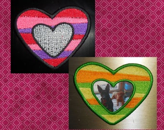 May include: Two free-standing lace hearts, one with pink, red, and purple stripes and a white lace center, and the other with green, yellow, and orange stripes and a photo frame in the center. The text "Free Standing Lace Hearts #1" is below the hearts.
