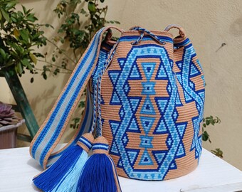 Wayuu mochila bag in single thread. Wayuu Traditional Drawing in sea blue color on a sand background. Premium quality.