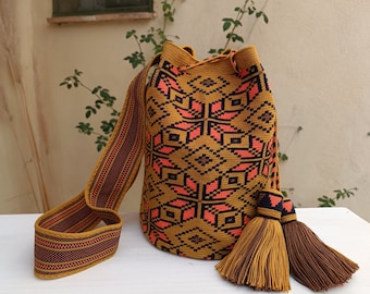 Wayuu mochila bag in single thread. Wayuu Traditional Drawing made in orange on a mustard background. Premium quality.