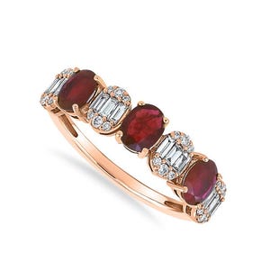 May include: Rose gold ring featuring five oval-cut, deep red rubies. The rubies are interspersed with clusters of baguette-cut diamonds and small round diamonds. The ring's band is a delicate, polished rose gold.