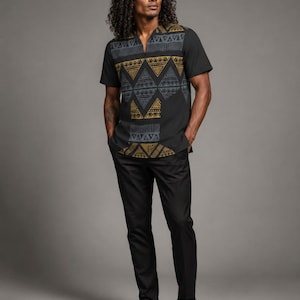 May include: A short-sleeved black shirt featuring a V-neckline and a prominent chest panel decorated with a repeating geometric pattern in shades of mustard yellow and dark gray, paired with solid black trousers and black dress shoes.