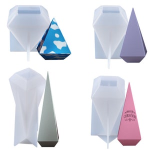May include: Four sets of silicone moulds for making pyramid-shaped candles. Each set includes a diamond-shaped mould and a pyramid mould. The pyramid moulds are in different colours: blue, purple, green, and pink. The pink pyramid mould has the text "Merry Christmas" printed on it.