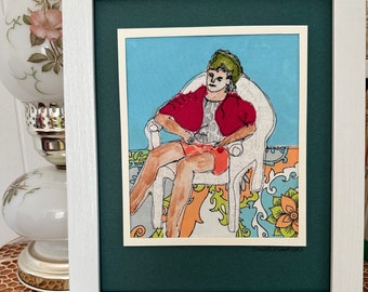 Unique machine-stitched portrait of a woman lounging, figure enhanced with fabric and watercolor. One-of-a-kind framed textile wall art.