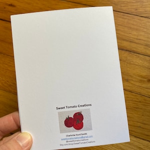 May include: A white card featuring the text "Sweet Tomato Creations" and a watercolour illustration of three red tomatoes. Contact details for Charlotte Hord Smith are also included.