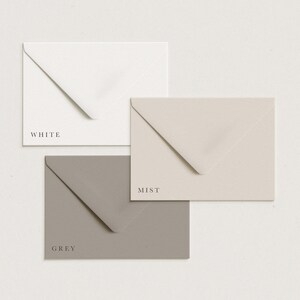 May include: Three envelopes in different colors: white, grey, and a light beige color called "mist".
