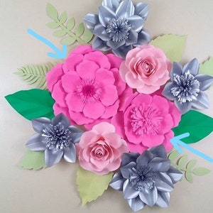 May include: A collection of handmade paper flowers in shades of pink and silver, with green and light green leaves. The arrangement includes large, multi-petaled flowers and smaller rose-like blooms.