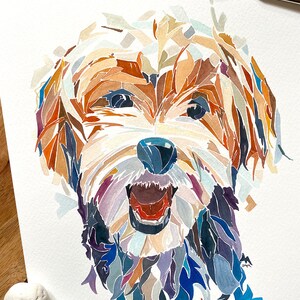 May include: Watercolour painting of a dog's face. The dog is a terrier mix with brown, white and black fur. The dog's mouth is open and its tongue is sticking out. The painting is done in a colourful, abstract style.
