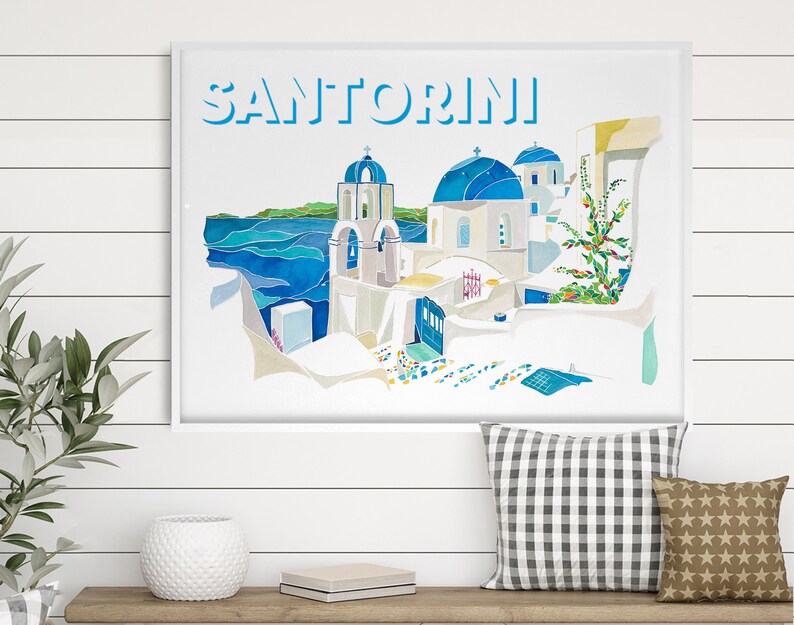 K&ouml;nnte beinhalten: Ein Aquarellbild eines wei&szlig;en Geb&auml;udes mit blauen Kuppeln in Santorini, Griechenland. Das Bild ist mit "SANTORINI" in blauen Buchstaben betitelt.