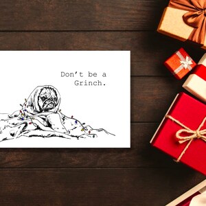 May include: A black and white illustration of a pug dog wrapped in Christmas lights with the text "Don't be a Grinch."