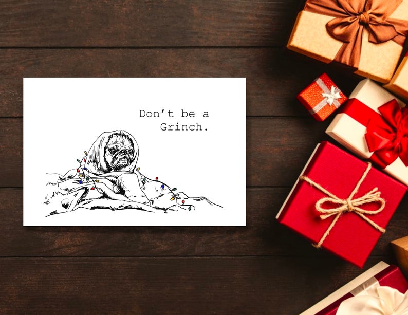 May include: A black and white illustration of a pug dog wrapped in Christmas lights with the text "Don't be a Grinch."