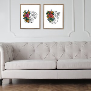 May include: Two black and white illustrations of a dog's head with a floral wreath around its face. The flowers are in shades of pink, red, orange, and yellow.