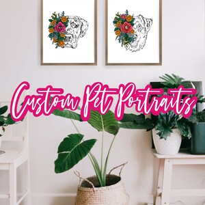 May include: Two custom pet portraits of dogs with floral wreaths around their heads. The portraits are in black and white and are framed in wood. The text "Custom Pet Portraits" is written in pink letters below the portraits.