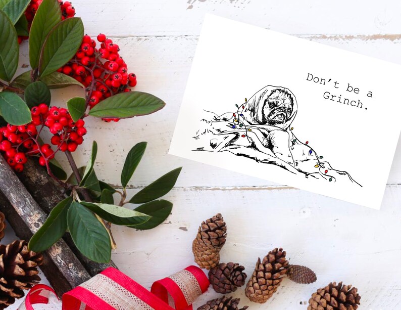 May include: A black and white illustration of a dog wrapped in Christmas lights with the text "Don't be a Grinch."